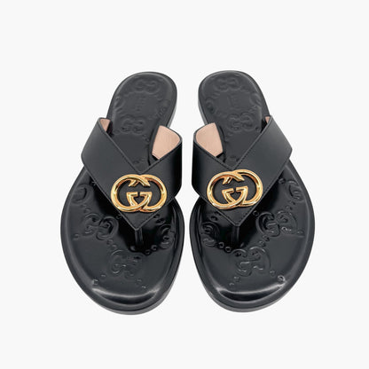 Gucci GG Interlock Embossed Flat Thong Sandals in Black Leather – Size 37
